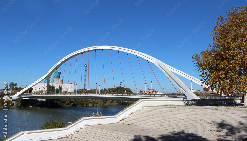 Obraz premium The Puente de la Barqueta (bridge of the barges), officially named Puente Mapfre a bridge over the Canal de Alfonso XIII in Seville, Spain.