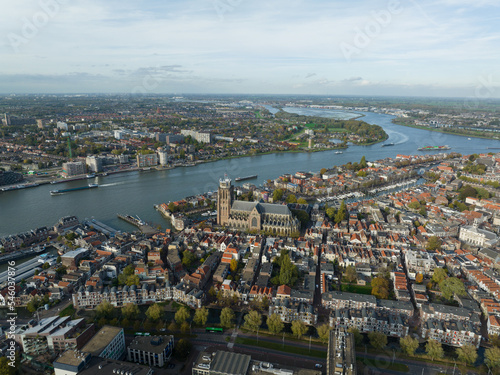 City center of Dordrecht  Dordt  South Holland  The Netherlands skyline along the Oude Maas river canal. Grote Kerk and historic traditional heritage city town. Aerial drone over view.