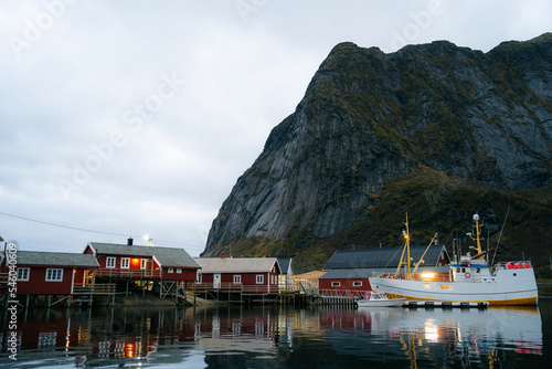 Sceninc View at Reine at Lofoten Islands in Norway with reflexions of robuer and boats on the water photo