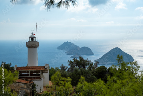 Lighthouse on the hill with islands on a background