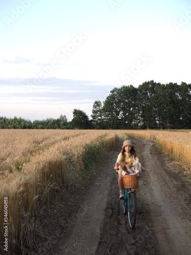 the girl rides a bicycle across the field © Nika Vero