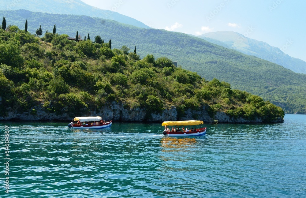 Naklejka premium a small tourist boat on the lake
