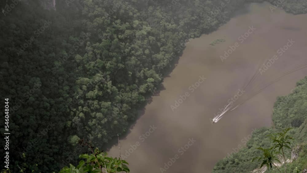 A boat is sailing across the Sumidero Canyon river A boat is sailing across the Sumidero Canyon river