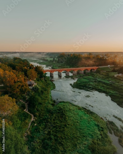 Aerial view of a bridge over lake in the countryside at dreamy sunlight