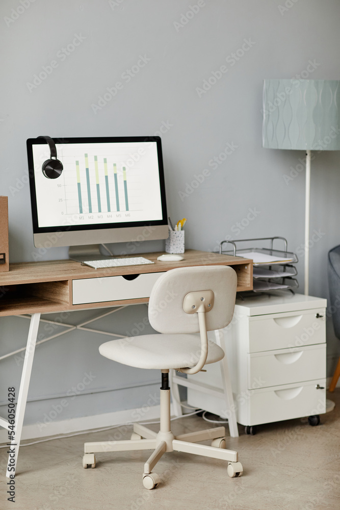 Vertical background image of minimal home office workplace in white with computer on wooden desk, copy space