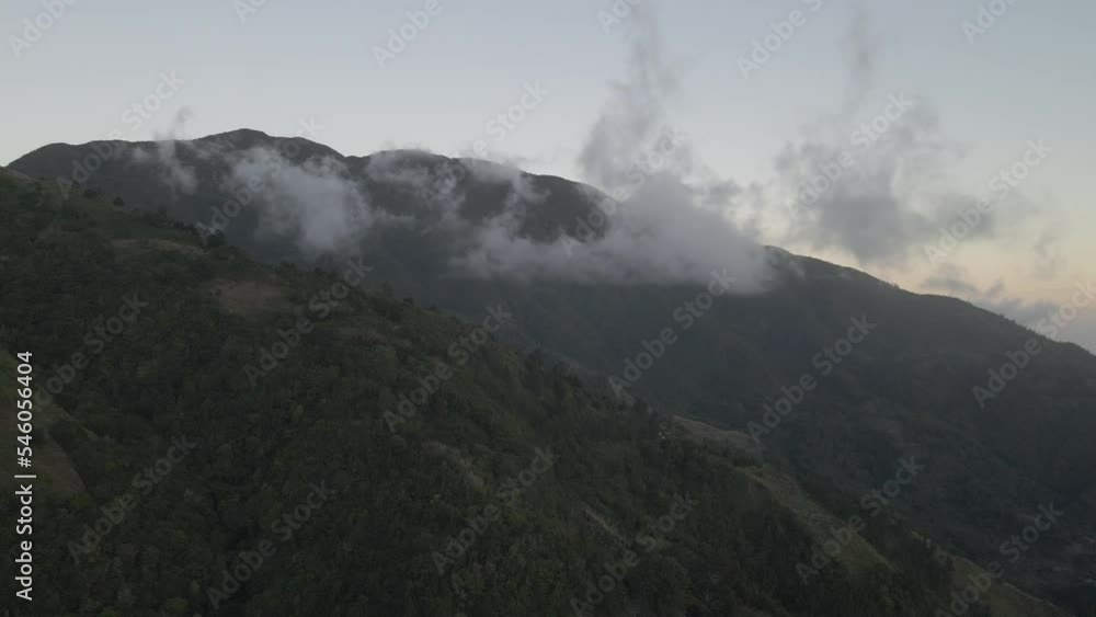Scenic drone view of the clouds over the green mountains at sunrise Scenic drone view of the clouds over the green mountains at sunrise