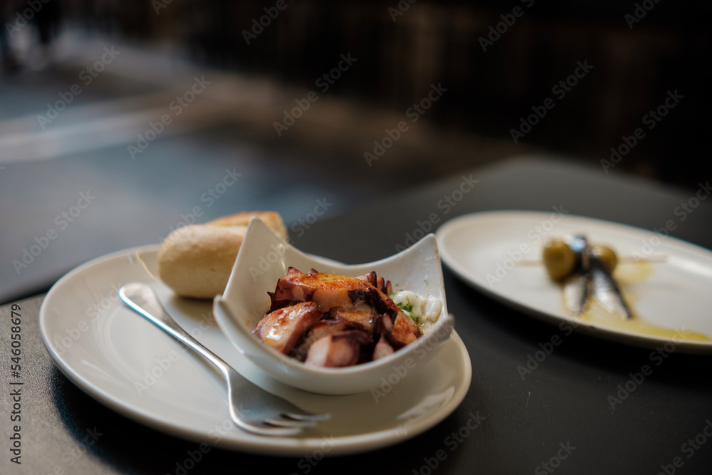 Traditional spanish tapa called Galician octopus on a table in the street. Traditional spanish tapa called Galician octopus on a table in the street.