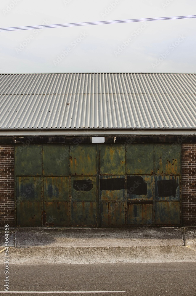 Vertical shot of an old building with rusty doors Vertical shot of an old building with rusty doors