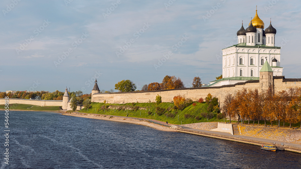 View from the Velikaya River to the Trinity Cathedral of the Pskov Kremlin against the blue autumn sky