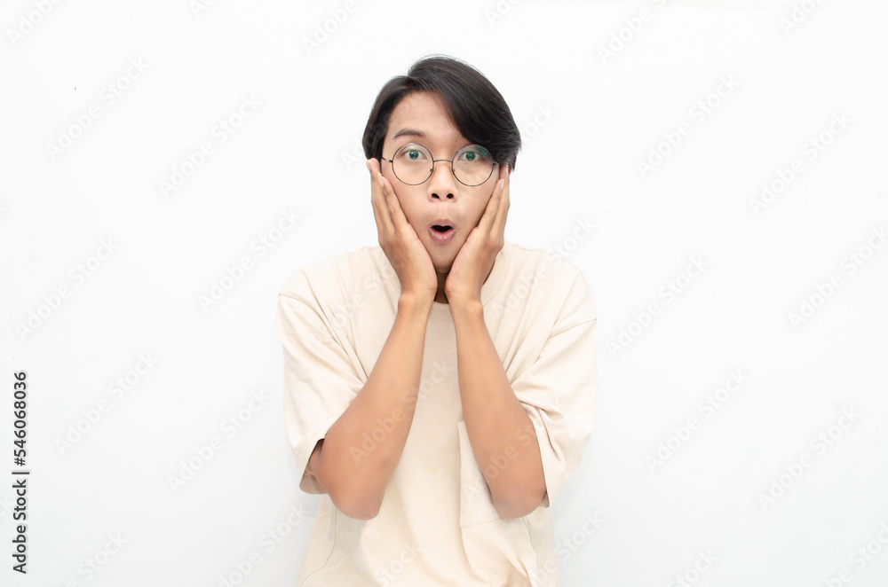 ecstatic attractive young asian man shocked happily opening mouth and lowering glasses. asian man with glasses feels shock with wow surprised expression. ecstatic attractive young asian man shocked happily opening mouth and lowering glasses. asian man with glasses feels shock with wow surprised expression.