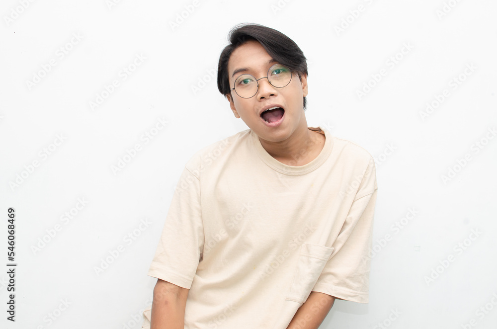 ecstatic attractive young asian man shocked happily opening mouth and lowering glasses. asian man with glasses feels shock with wow surprised expression. ecstatic attractive young asian man shocked happily opening mouth and lowering glasses. asian man with glasses feels shock with wow surprised expression.