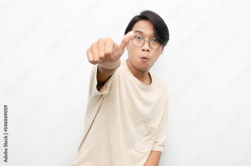 handsome attractive Asian man smiling happily and giving thumbs up as ...