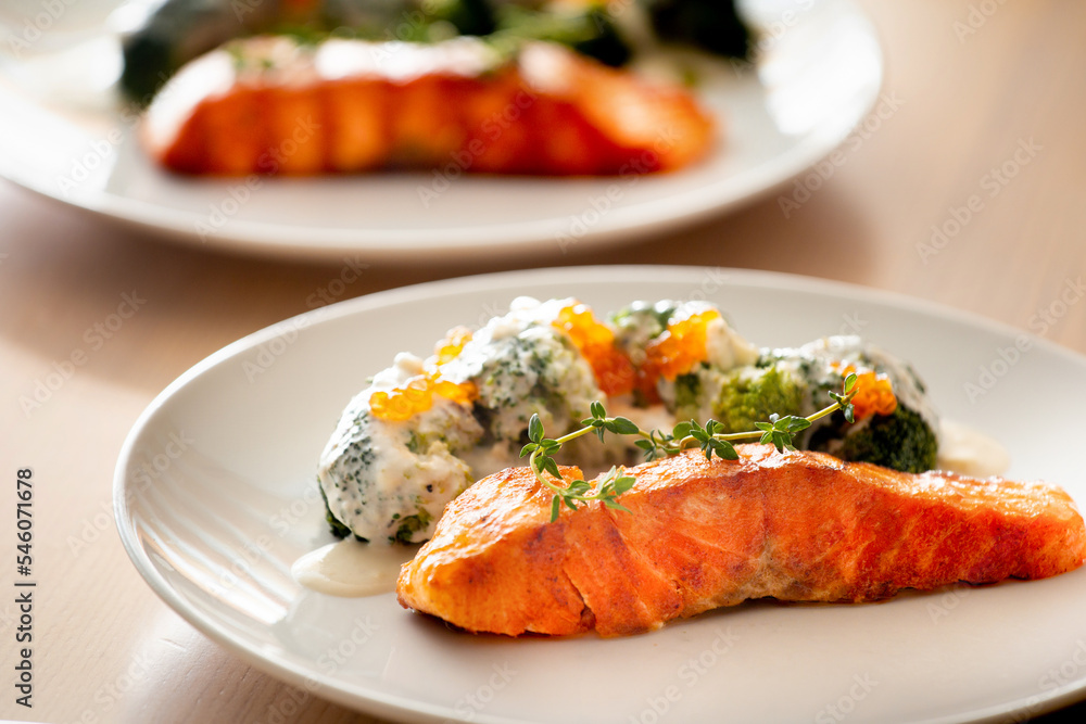 Salmon steak with broccoli on a white plate. Salmon steak with broccoli on a white plate.