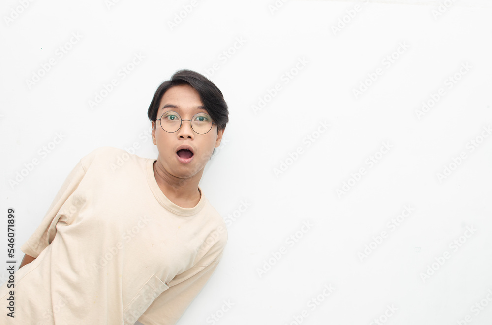 ecstatic attractive young asian man shocked happily opening mouth and lowering glasses. asian man with glasses feels shock with wow surprised expression. ecstatic attractive young asian man shocked happily opening mouth and lowering glasses. asian man with glasses feels shock with wow surprised expression.