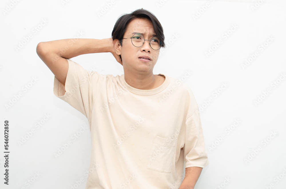 Thoughtful confused asian man thinking and wondering to choose something isolated over white background. man feeling uncertain and unsure. Thoughtful confused asian man thinking and wondering to choose something isolated over white background. man feeling uncertain and unsure.