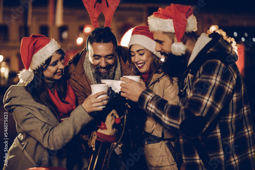 Friends Enjoying Hot Wine At The Christmas Market