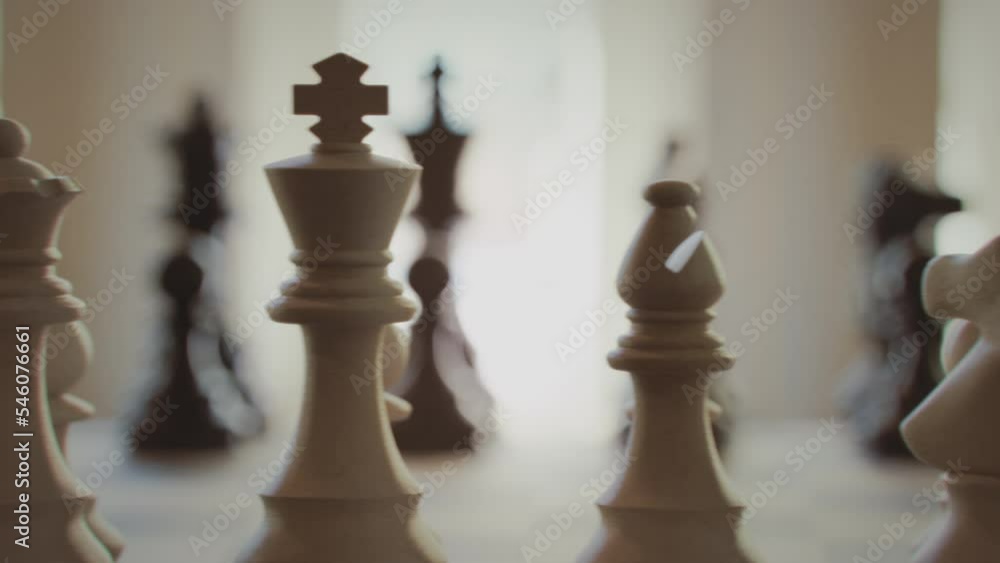 The game of chess. Close-up macro shot of chess pieces on the chessboard. Photorealistic studio shot 3d animation. The game of chess. Close-up macro shot of chess pieces on the chessboard. Photorealistic studio shot 3d animation.