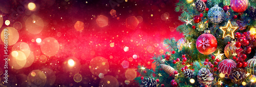 Fotografie, Obraz Christmas Tree In Red Shiny Background - Ornaments On Fir Branches With Glitteri