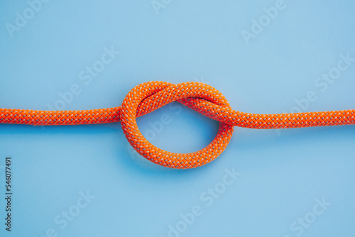 Orange Rope with a knot on blue background