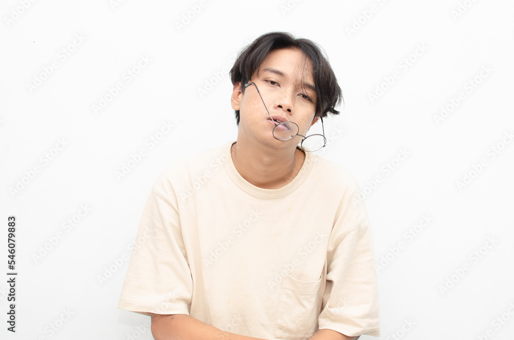asian man looks depressed and messed up. Irritated man bites lips and scratches head. stressed over work concept. asian man looks depressed and messed up. Irritated man bites lips and scratches head. stressed over work concept.