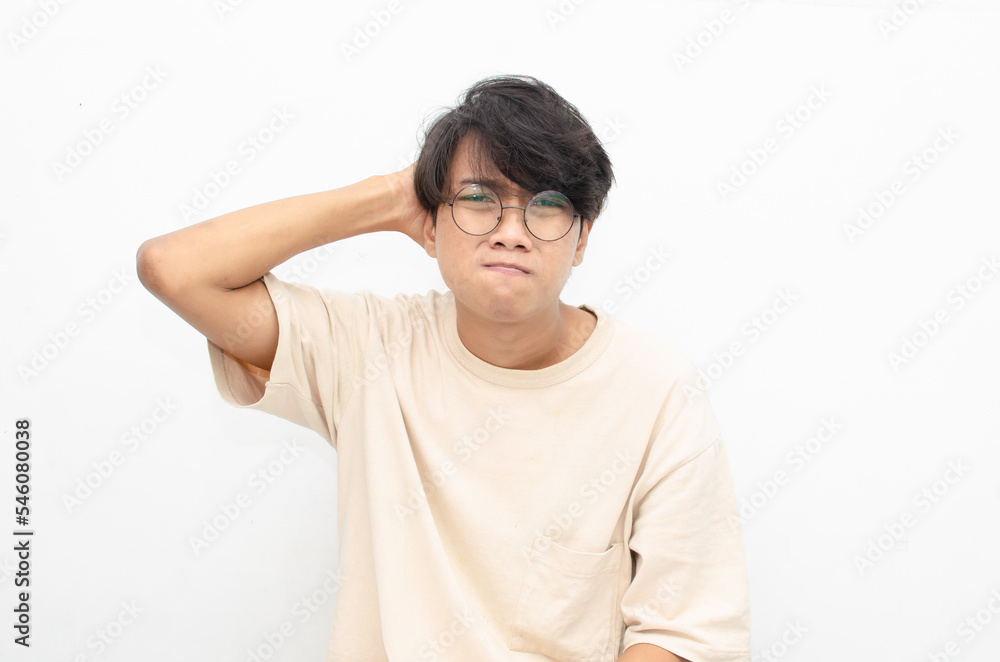 asian man looks depressed and messed up. Irritated man bites lips and scratches head. stressed over work concept. asian man looks depressed and messed up. Irritated man bites lips and scratches head. stressed over work concept.