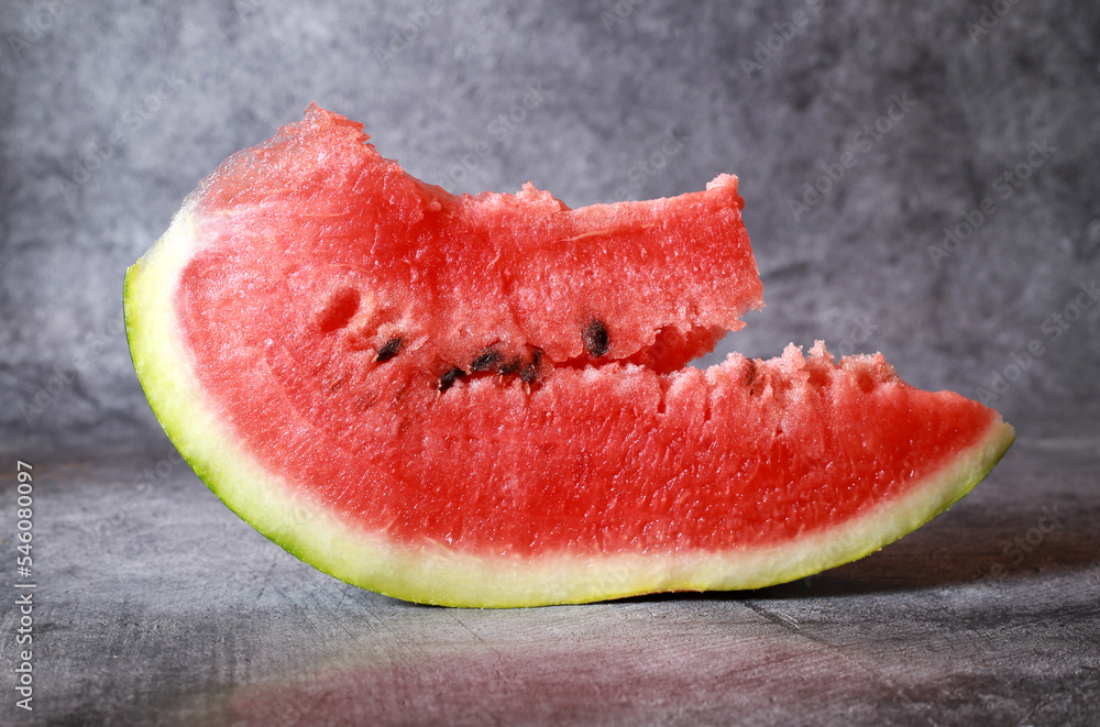 Slice of watermelon isolated on dark background Slice of watermelon isolated on dark background