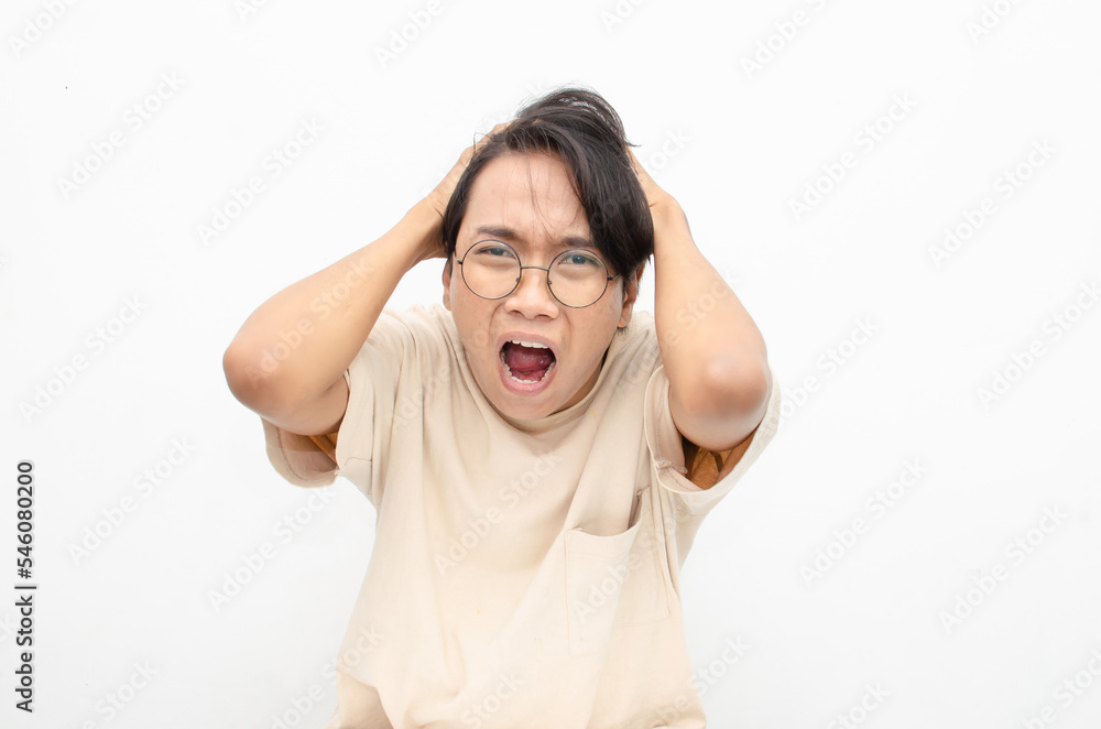 asian man looks depressed and messed up. Irritated man bites lips and scratches head. stressed over work concept. asian man looks depressed and messed up. Irritated man bites lips and scratches head. stressed over work concept.