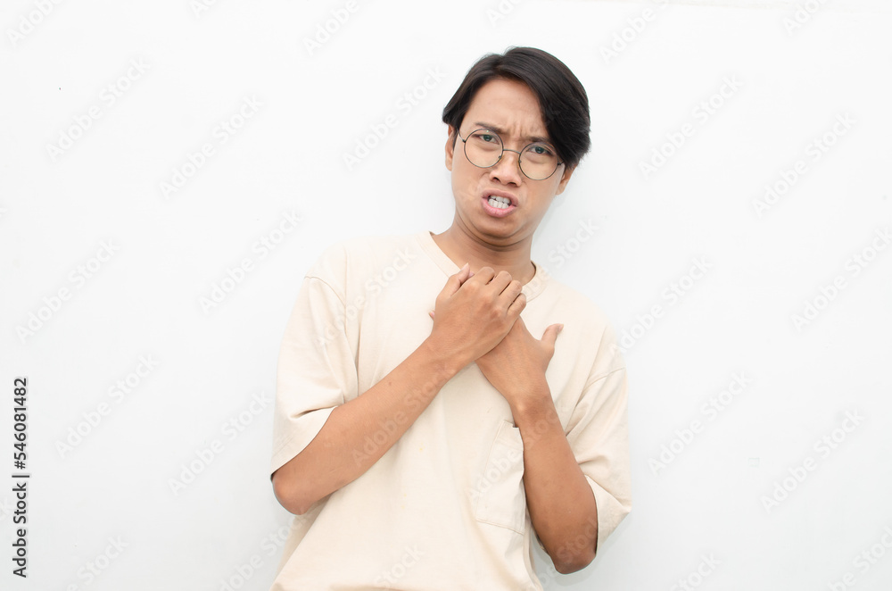 Ew. It's so gross. A young Asian man displaying an expression of dislike and disgust while covering nose with hand. stop han gesture by asian man Ew. It's so gross. A young Asian man displaying an expression of dislike and disgust while covering nose with hand. stop han gesture by asian man