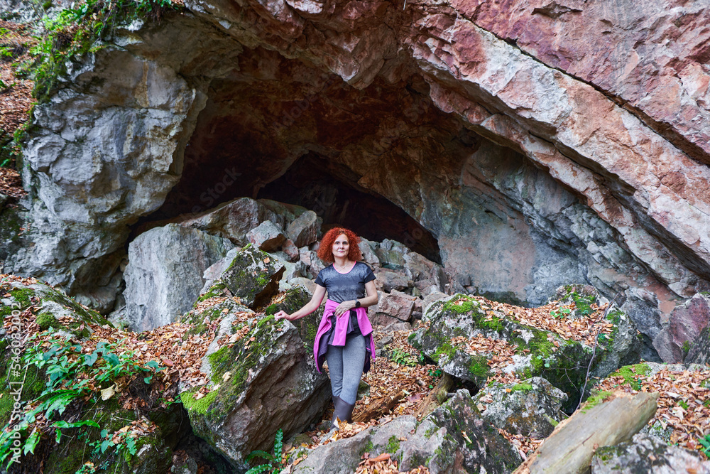 Woman by a cave entrance