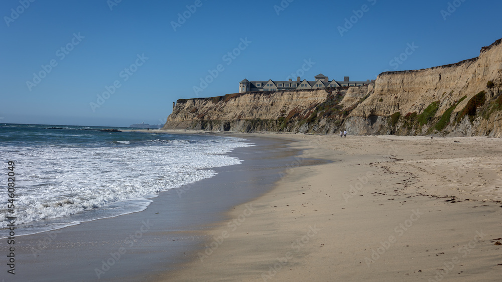 The beach at half moon bay with steep rocks and a view of the north pacific ocean, California, USA