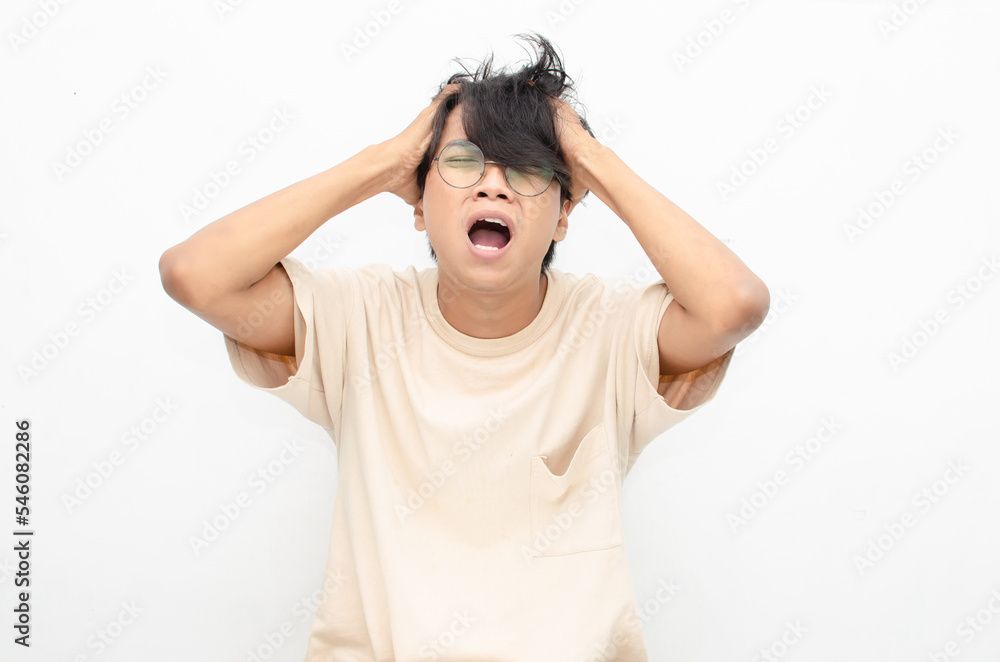 asian man looks depressed and messed up. Irritated man bites lips and scratches head. stressed over work concept. asian man looks depressed and messed up. Irritated man bites lips and scratches head. stressed over work concept.