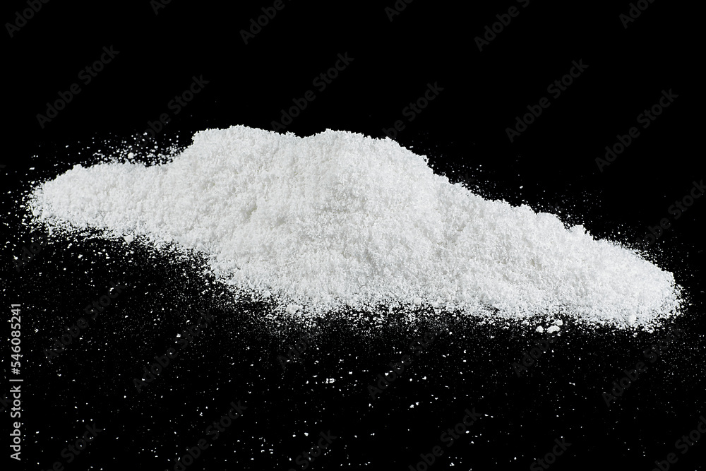 Pile of white snow isolated on a black background. Snow crystals. Snowdrift.