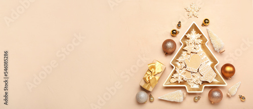 Christmas tree made of tasty cookies and decorations on beige background with space for text