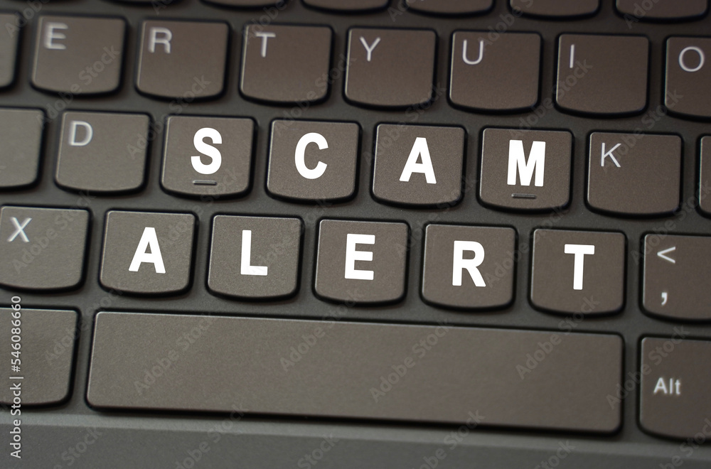 On the black keyboard, the inscription is highlighted in white - Scam Alert On the black keyboard, the inscription is highlighted in white - Scam Alert