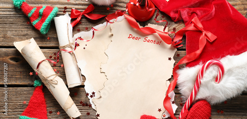 Composition with blank letter to Santa, hat and Christmas decor on wooden background