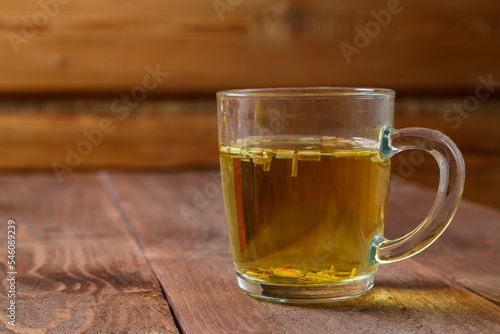 tea cup transparent lemongrass on a wooden table.