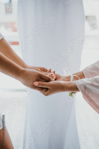 Selective focus shot of girls holding hands, a concept of friendship and sincere love