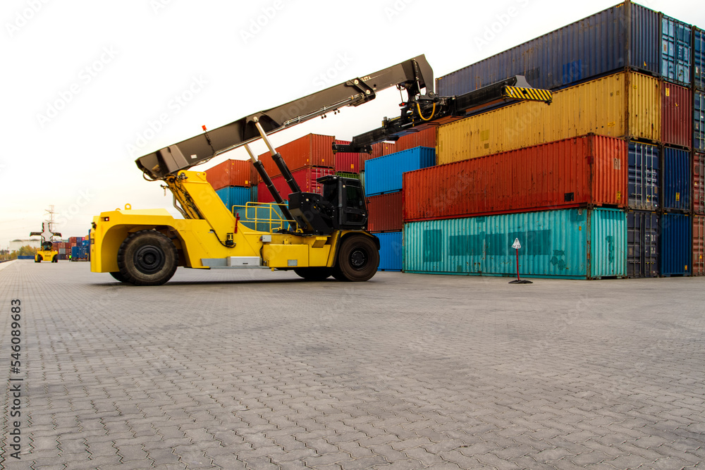Forklift handling cargo container. Freight container loading. Container handler. Logistics import export concept. Industrial container logistic yard. Forklift handling cargo container. Freight container loading. Container handler. Logistics import export concept. Industrial container logistic yard.