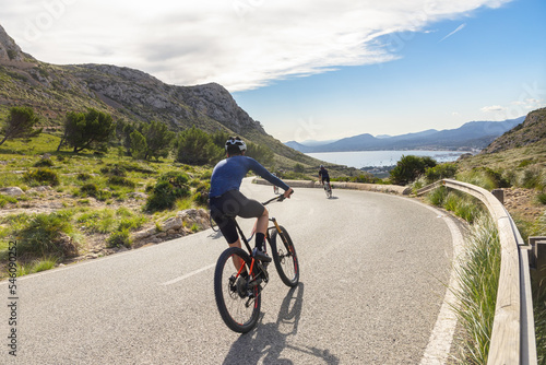 Ciclismo en Mallorca. Ciclistas bajando una cuesta hacia el puerto de Pollensa, en las montañas de la Serra de Tramuntana, cerca de Formentor, en Mallorca (Islas Baleares, España) photo