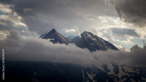 Bild auf Leinwand The beautiful panoramic view of mountain top shrouded in clouds