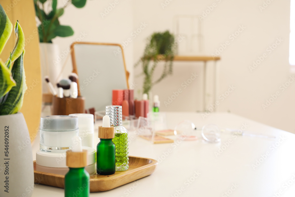 Different cosmetic products on table in room Different cosmetic products on table in room