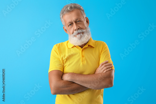 Senior bearded man in yello...