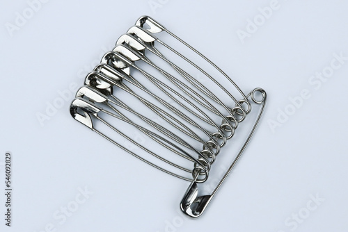 Metal safety pins isolated on white background