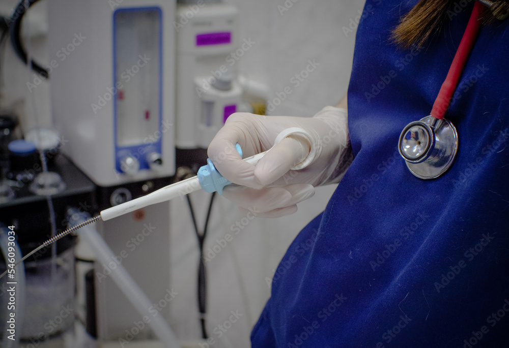 Physician assistant holding biopsy clamp during endoscopy. A patient