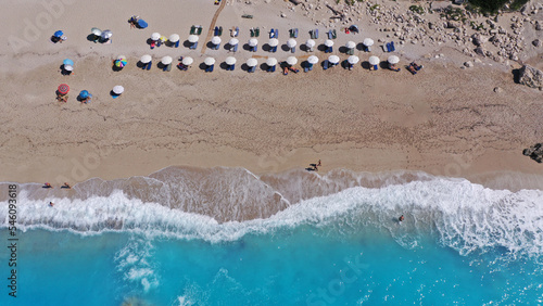 Aerial drone top down photo of paradise organised sandy - crystal clear turquoise sea beach in exotic island destination