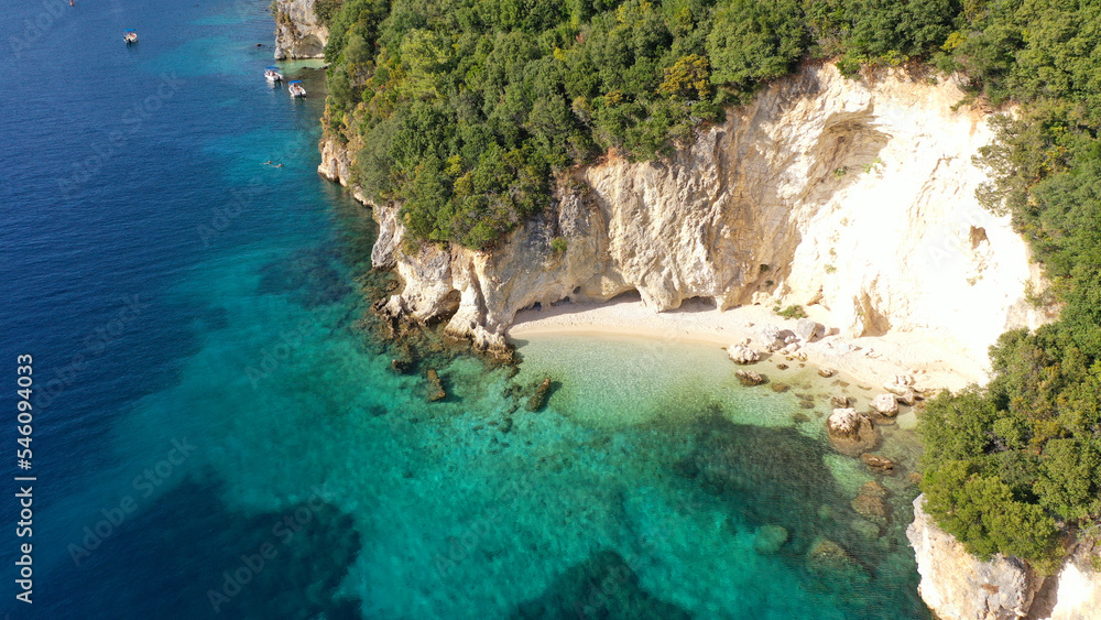 Aerial drone top down photo of tropical exotic paradise secluded rocky bay with deep turquoise sea forming a blue lagoon