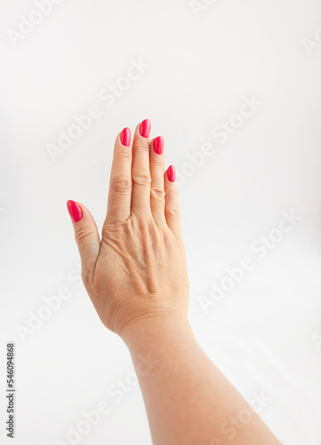 Woman's well-groomed hand, isolated on white background.