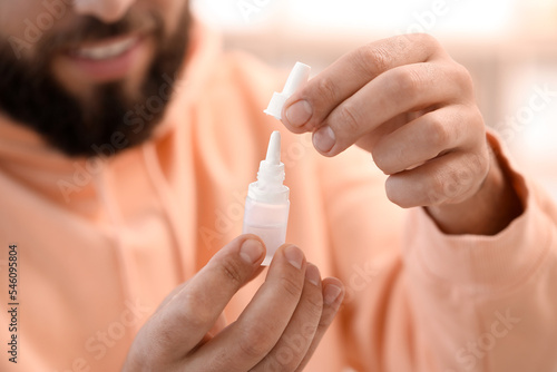 Handsome man with eye drops...