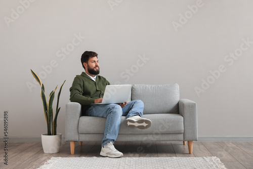 Handsome bearded man using ...
