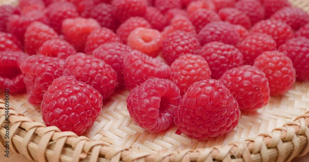 Juicy fresh organic raspberry fruits on basket Juicy fresh organic raspberry fruits on basket